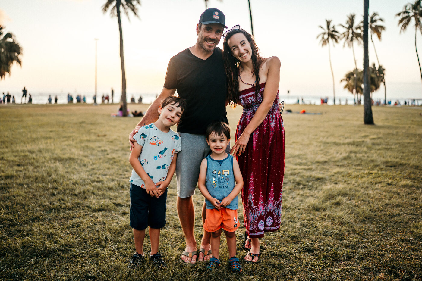 Family of four in park at sunset